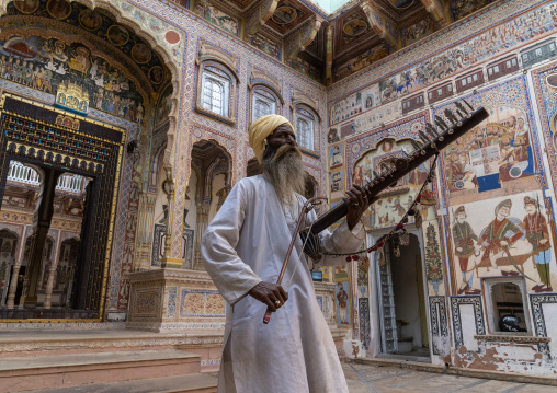 Musician playing sitar inside an old haveli courtyard, Rajasthan, Nawalgarh, India