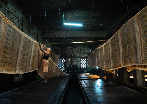 Indian worker drying textiles after manual Screen Printing, Rajasthan, Jaipur, India