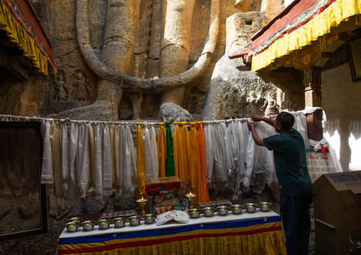 Indian man putting khatas in Mulbekh Gompa , Ladakh, Kargil, India