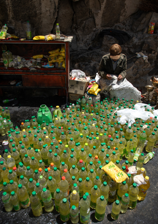Pilgrim cleaning oil lamps in Shey Monastery, Ladakh, Shey, India