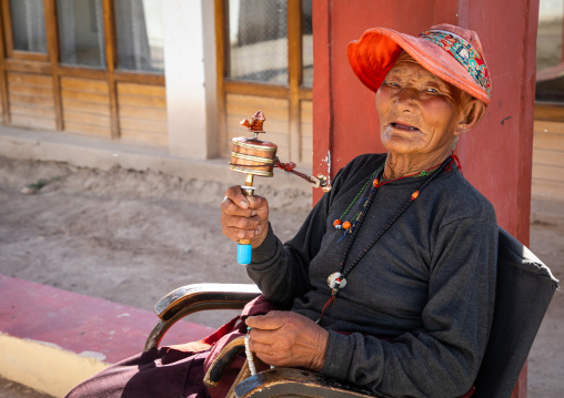 Tibetan man with a prayer wheel in Sonamling Tibetan settlement, Ladakh, Leh, India
