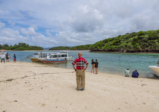 Tourists in tropical lagoon in Kabira bay, Yaeyama Islands, Ishigaki, Japan