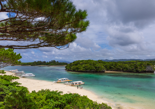 Glass bottom boats in tropical lagoon with clear blue water in Kabira bay, Yaeyama Islands, Ishigaki, Japan