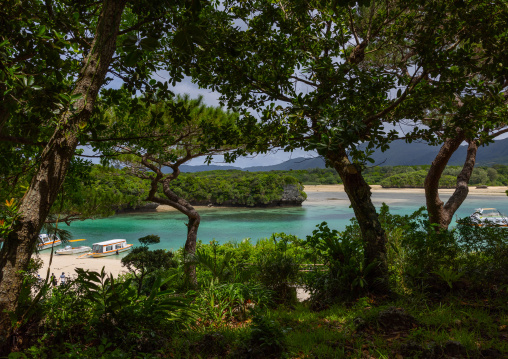 Glass bottom boats in tropical lagoon with clear blue water in Kabira bay, Yaeyama Islands, Ishigaki, Japan