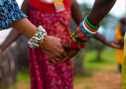 Western tourits dancing with samburu women, Samburu County, Samburu National Reserve, Kenya