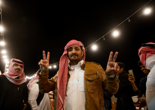 Saudi men dancing during King Abdul Aziz Camel Festival, Riyadh Province, Rimah, Saudi Arabia
