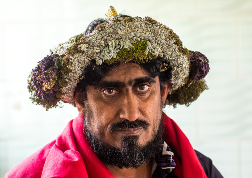 Portrait of a flower man wearing a floral crown on the head, Asir province, Sarat Abidah, Saudi Arabia