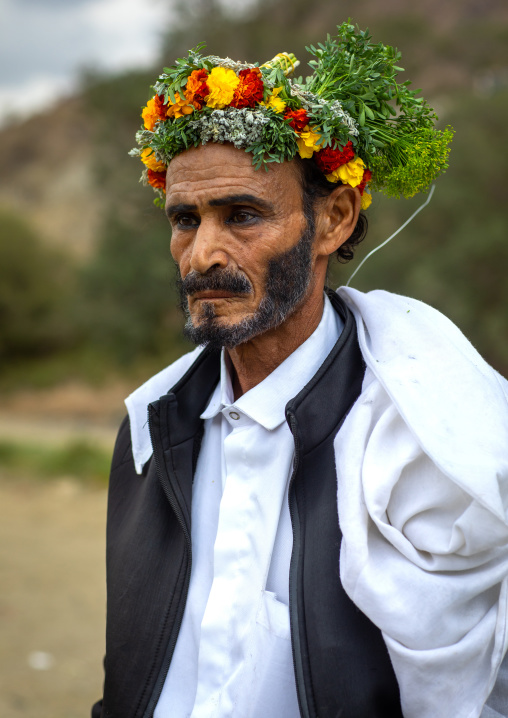 Portrait of a flower man wearing a floral crown on the head, Asir province, Sarat Abidah, Saudi Arabia