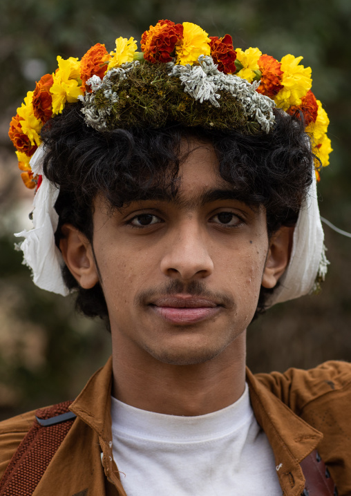 Portrait of a flower man wearing a floral crown on the head, Asir province, Sarat Abidah, Saudi Arabia