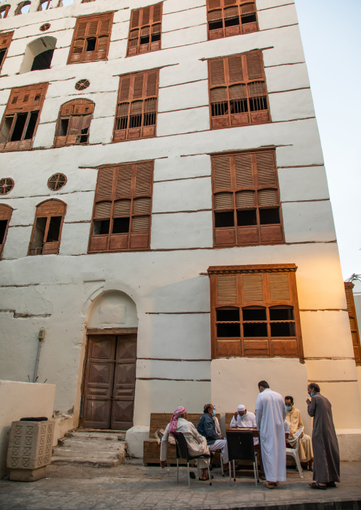 Men playing chess in front of an old house in al-Balad quarter, Mecca province, Jeddah, Saudi Arabia