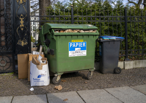 Overloaded paper containers in the street, Saxony, Leipzig, Germany