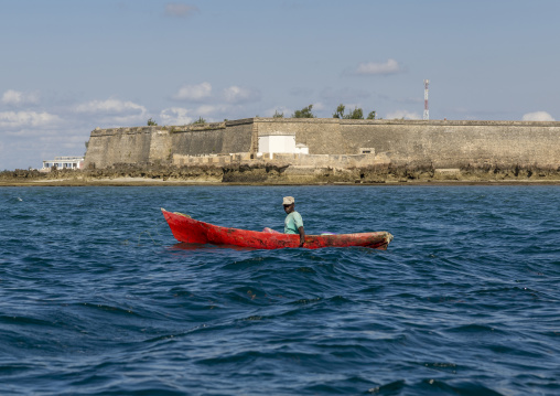 Fisherman in a canoe in front of Saint Sebastian Fortress, Nampula Province, Island of Mozambique, Mozambique
