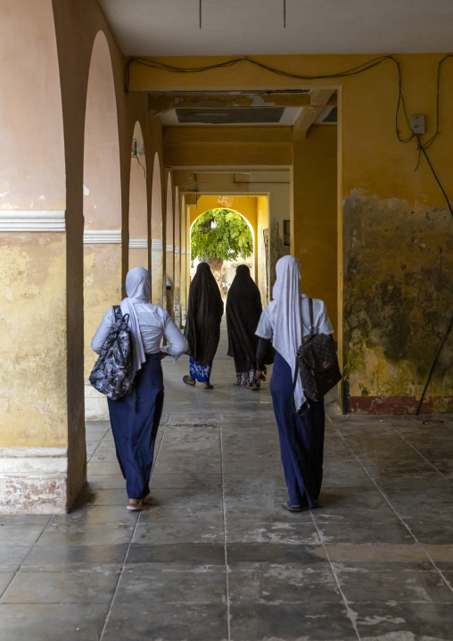 Muslim girls walking under a covered alley in Stone town, Nampula Province, Island of Mozambique, Mozambique
