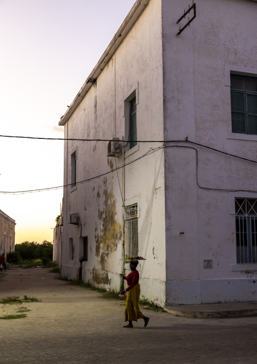 Woman in front of an old colonial portuguese building, Nampula Province, Island of Mozambique, Mozambique