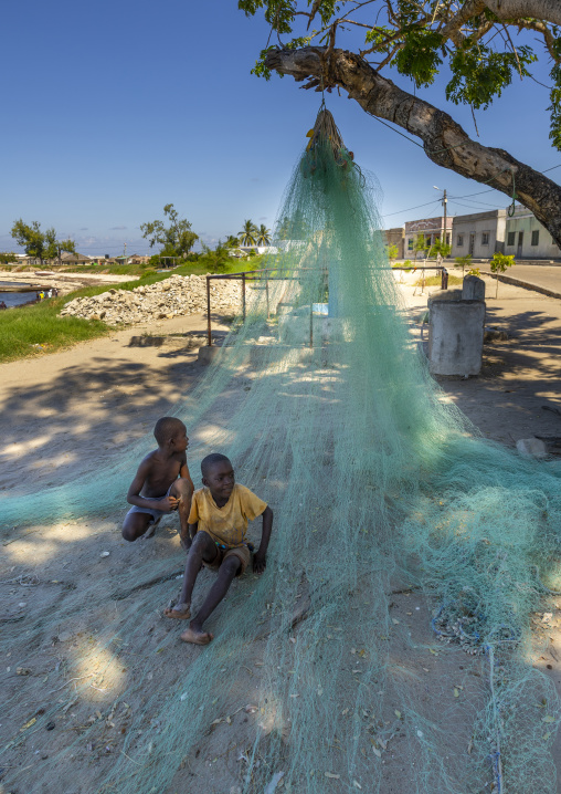 Boys resting on fishing nets, Nampula Province, Island of Mozambique, Mozambique