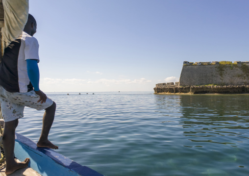 Man on a dhow in front of Saint Sebastian fortress, Nampula Province, Island of Mozambique, Mozambique