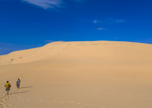 Tourists walking on sand dune in Bazaruto national park, Bazaruto archipelago, Bazaruto island, Mozambique