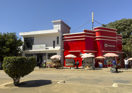 Colonial building painted in red to promote Vodacom, Nampula Province, Nampula, Mozambique