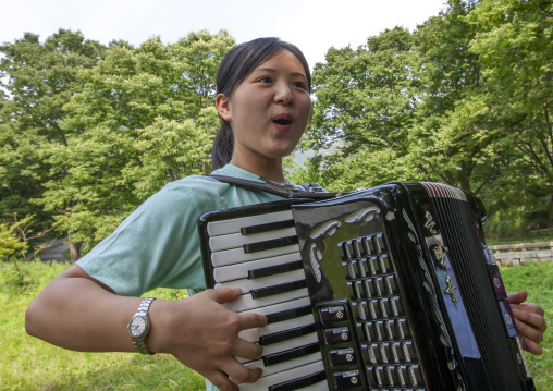 Japanese people originated from North Korea playing accordion, North Hwanghae, Sariwon, North Korea