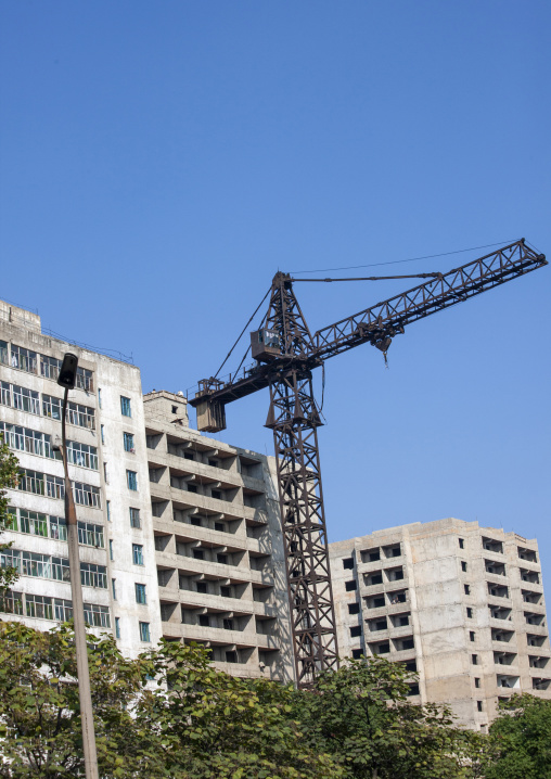 Crane in the middle of buildings, North Hwanghae, Kaesong, North Korea