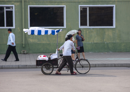 North Korean woman selling drinks in the street on a tricycle, DGC, Pyongyang, North Korea