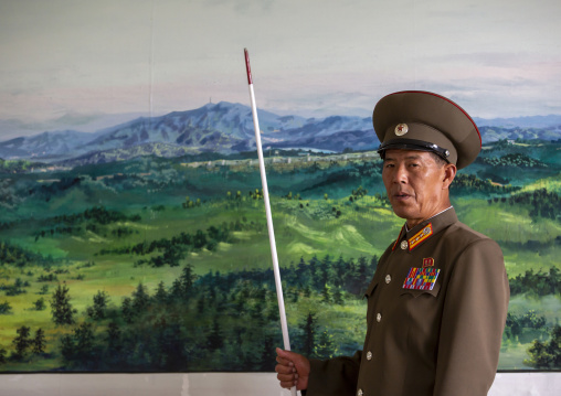 Soldier in the DMZ in front of the map of the wall, North Hwanghae, Panmunjom, North Korea