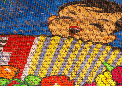 Children holding up boards during Arirang to create a boy playing accordion, DGC, Pyongyang, North Korea