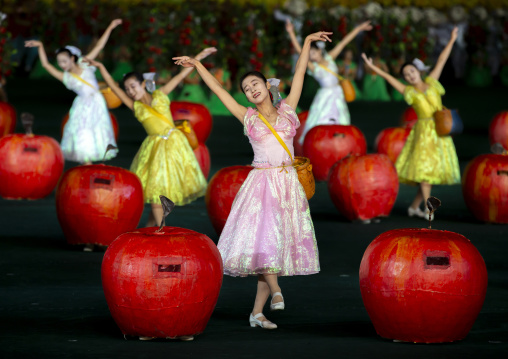 Women dancing between apples at Arirang mass games, DGC, Pyongyang, North Korea