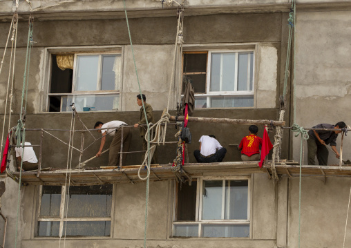 North Korean workmen on a dangerous scaffolding, South Hamgyong, Hamhung, North Korea