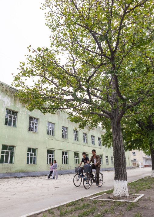 North korean people on bicycles in the street, North Hwanghae, Kaesong, North Korea