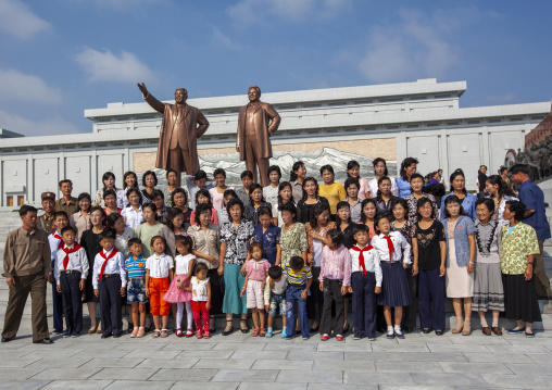 People posing in front of the statues of the Leaders in the Grand monument, DGC, Pyongyang, North Korea