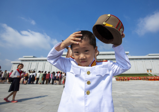 North Korean boy in army uniform putting his kepi in Grand monument, DGC, Pyongyang, North Korea