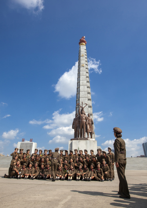 North Korean female soldiers posing in front of the Juche tower, DGC, Pyongyang, North Korea