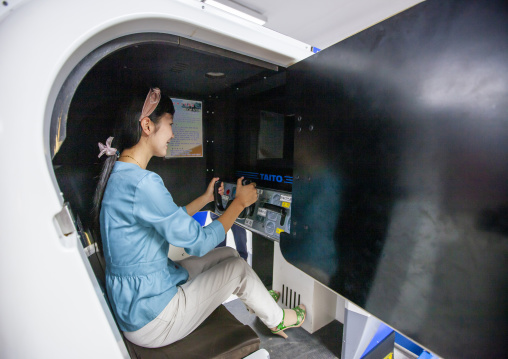 North Korean woman playing video games in Kaeson youth park, DGC, Pyongyang, North Korea