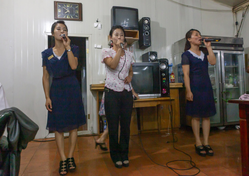 North Korean waitresses singing karaoke in a restautant, DGC, Pyongyang, North Korea