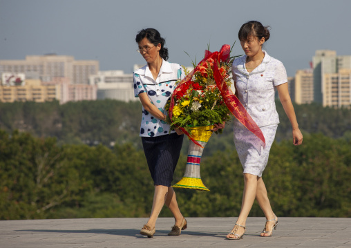Women bringing flowers in Mansudae Grand monument, DGC, Pyongyang, North Korea