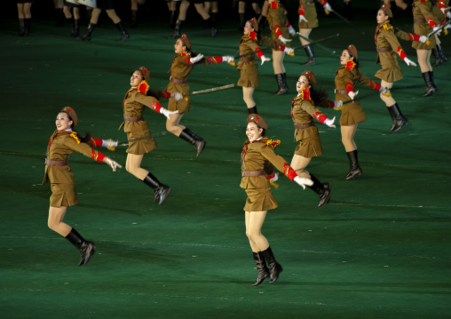 Women dressed as soldiers dancing with swords during the Arirang, DGC, Pyongyang, North Korea
