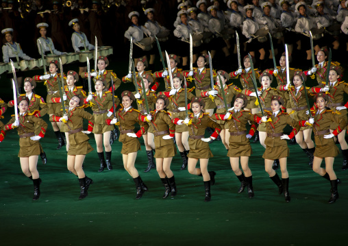 Women dressed as soldiers dancing with swords during the Arirang, DGC, Pyongyang, North Korea