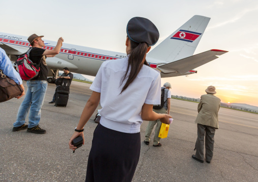 North Korean airport employee and tourists, DGC, Pyongyang, North Korea