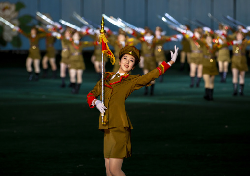 Women dressed as soldiers dancing with swords during the Arirang mass games, DGC, Pyongyang, North Korea