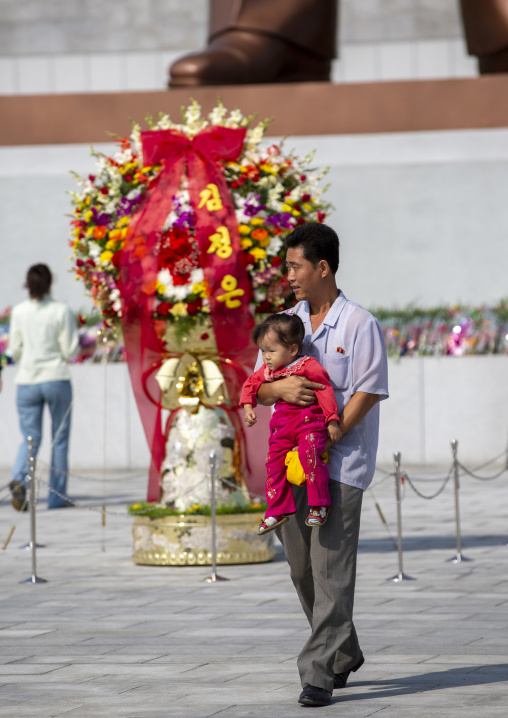 Father and his daughter paying respect in the Grand monument, DGC, Pyongyang, North Korea