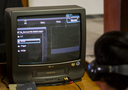 North Korean man watching a dvd at the Grand people's study house, DGC, Pyongyang, North Korea