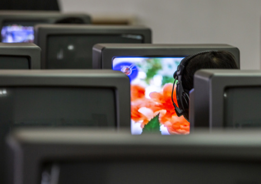 North Korean man watching a dvd at the Grand people's study house, DGC, Pyongyang, North Korea