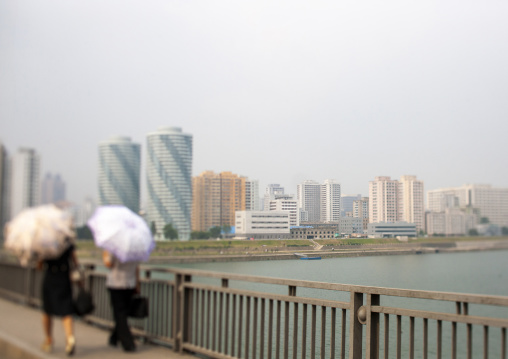 North Korean women with umbrellas in the street, DGC, Pyongyang, North Korea