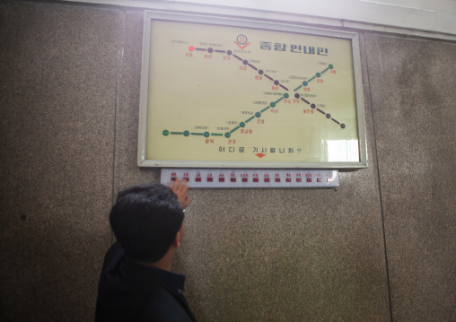 North Korean man testing the electronic board of the metro lines, DGC, Pyongyang, North Korea