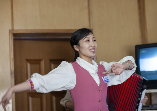 North Korean waitress dancing in a restaurant, DGC, Pyongyang, North Korea