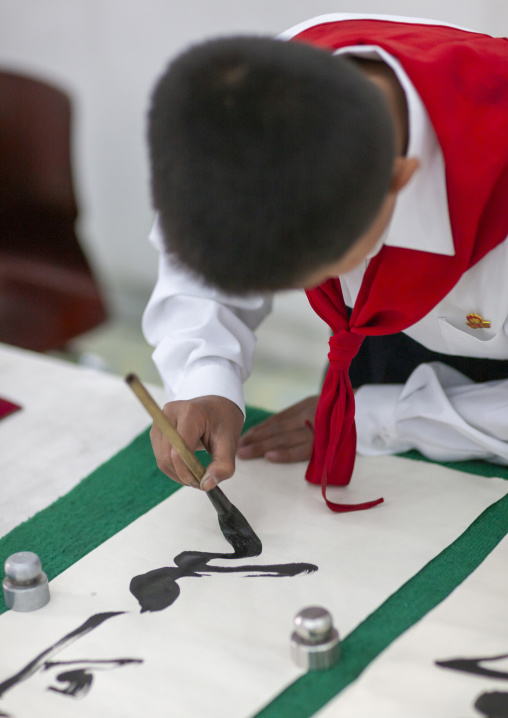 Pioneer boy in a calligraphy workshop in Mangyongdae children's palace, DGC, Pyongyang, North Korea