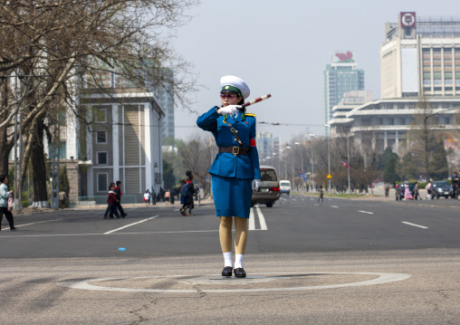 North Korean female traffic security officer in blue uniform in the street, DGC, Pyongyang, North Korea