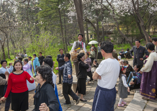 North Korean women dancing in a park for the day of the sun, DGC, Pyongyang, North Korea