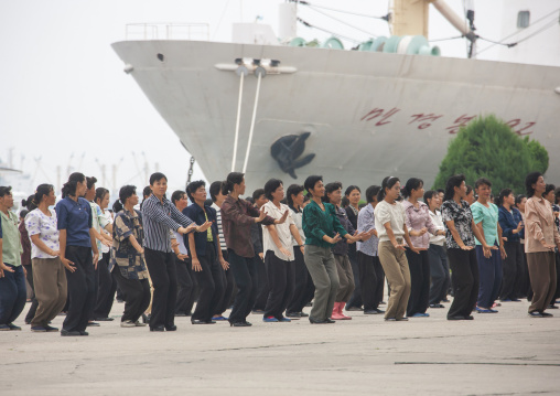 Women raising hands during morning exercise session, Kangwon Province, Wonsan, North Korea